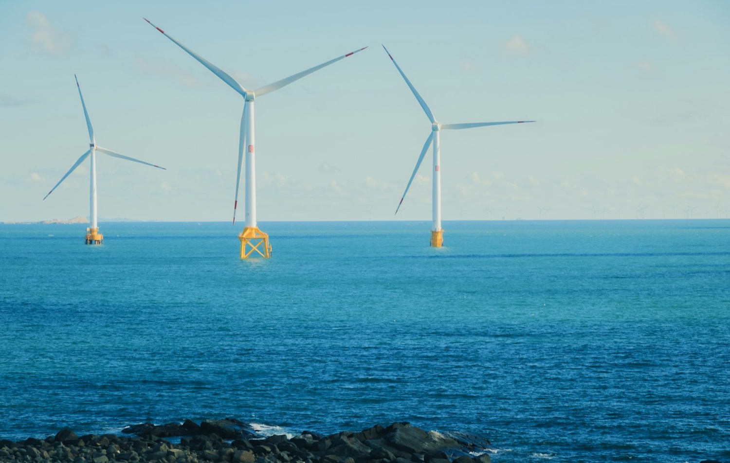 Offshore wind turbines at sea on a clear day