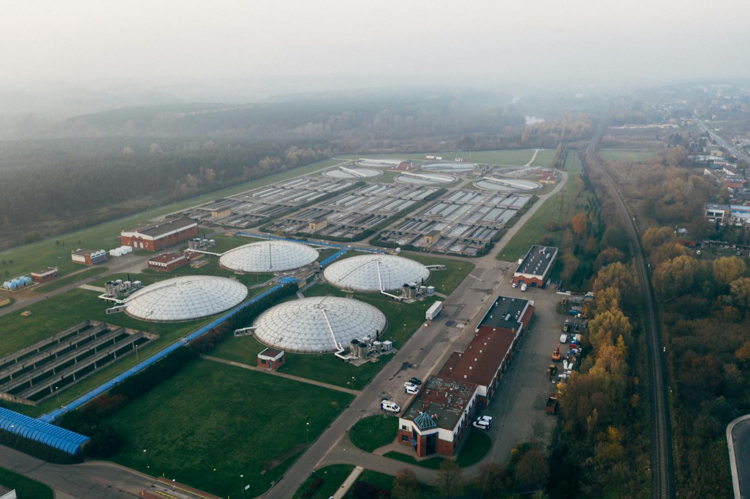 Aerial view of a wastewater treatment plant with circular aeration tanks